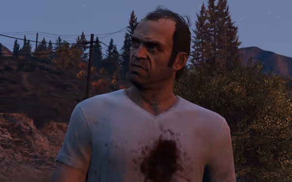 A bruised man in a bloodstained white shirt stares intensely outdoors at dusk.