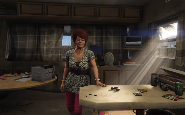 A woman with red hair stands inside a cluttered room lit by sunlight through a window.