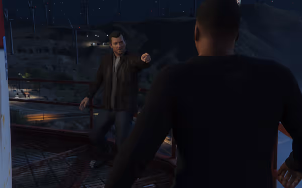 The image shows two men facing off on a metal platform at night, with wind turbines in the background.