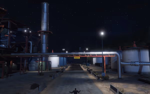 The image shows a dark industrial area with a road, pipes, and a warning sign overhead.