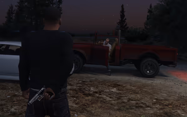 A man with a gun tucked behind approaches another sitting in a red truck at night in woods.