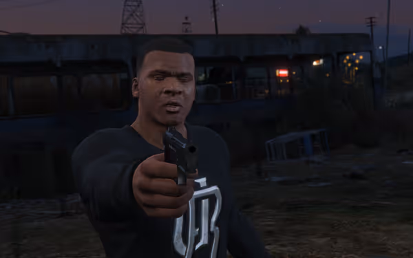 A man in a black shirt points a gun, with a train wreck in the background.