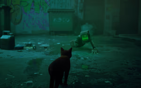 A cat faces a crawling robot with a glowing green screen in a grimy alley.