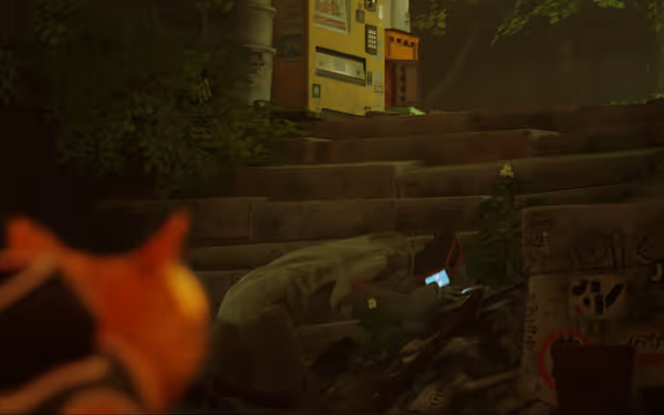 An orange cat with a vest stares at a slumped robot on stairs near graffiti.